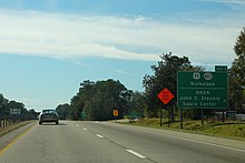A big green sign on the left side of the four-lane Interstate 59. The sign depicts the shields of Mississippi Highway 607 and U.S. Route 90. Highway 607 has a white circular shield with the number in black text. The destinations listed on the sign are Nicholson and the John C. Stennis Space Center. The exit is the first eastbound one in Mississippi, thus listed as Exit 1.