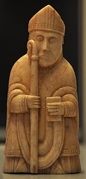 Photograph of an ivory gaming piece depicting a bishop