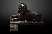 The Bronze Sphinx of Thutmose III reclining over the Nine Bows; the Djed pillars of Dominion are featured on the side of the socle