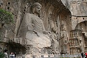 Tang dynasty statue of Vairocana (Dàrì Rúlái) at Longmen Grottoes, Luoyang, Henan, China. The statue was completed in the year 676 and is 17.14 m high and has 2 m long ears.