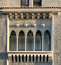 Mediterranean Revival (late revivalism) lion mascarons above a series of window of Strada George Enescu no. 14, Bucharest, unknown architect, c.1930