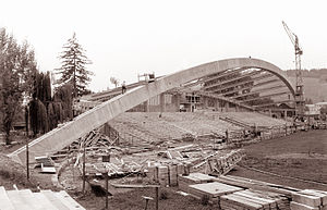 Black and white photo of a football stand under construction.