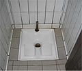 5 A French Squat Toilet. Shows a nice, clean porcelain model used in Europe.