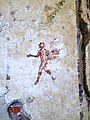 A mural of a striding Satyr carrying the thyrsus painted in the 1st century AD. Archaeological park of Baiae.