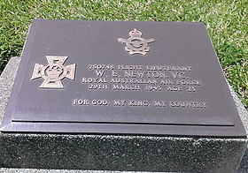 Rectangular metal plaque grave marker on flat headstone