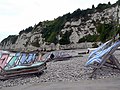 Deckchairs on beach at Beer, Devon, England, both open and stacked