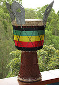 Djembe decorated with folded-over skin, sege sege, rope wrap, and metalwork