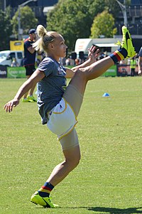 Phillips demonstrating her right leg flexibility while kicking