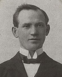 Young, clean-shaven man, in wing collar