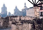 Foreground: ruins of Templo Mayor. Background: Mexico City Metropolitan Cathedral