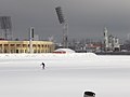 Facade of the stadium in winter and a view of St. Vladimir's Cathedral