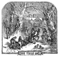 Engraving of four men and two boys dragging a large log through the snow on a path between trees towards a big house. They are surrounded by a man on one side, and a woman with a boy on the other side. The man and the boy are cheering at them. All are dressed according to British fashion of the 19th century.