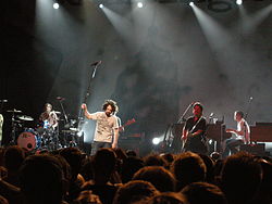 Counting Crows in Brussels, 2008. Left to right: Bogios, Duritz, Immerglück, and Gillingham. Vickrey is cut off at the left, Powers is behind Duritz; Bryson is out of frame.