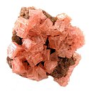 Pink color halite on a matrix covered with minute nahcolite