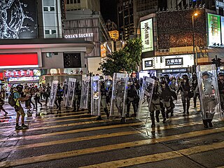 Riot police in the streets at night