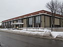 North Regional, a tall, one-story glass and concrete library on a snowy, cloudy day