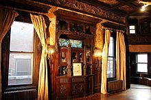 The Paine Mansion (Pi Kappa Phi Fraternity House) dining room showing a Tiffany stained glass window, built in buffet, cherry inlaid floors and the choir loft.