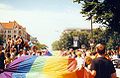 Marchers carry the LGBT pride flag at the pride parade on Christopher Street Day, Berlin, Germany (1997)