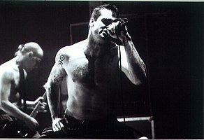Founder and frontman Henry Rollins with Chris Haskett (background)