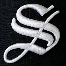 Logo of the Ingolstadt Schanzer, a german baseball team. A white S on a navyblue baseball cap.