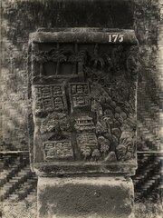 A relief from Trowulan, showing several walled compounds and a larger wall to their north.
