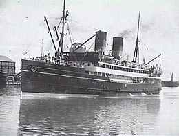 Black and white photograph of passenger ship with twin funnels, under steam