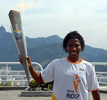 Soccer player Pretinha pictured holding the Pan-American Games torch