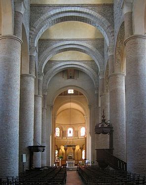 The Church of St. Philibert, Tournus, has tall circular piers and is roofed with transverse arches supporting a series of barrel vaults.