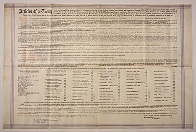 A large piece of parchment paper on which is written the terms of Treaty 7.