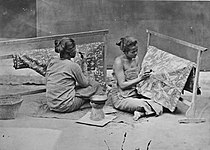 Two Javanese women making batik cloths in a village in Java, between 1870 and 1900
