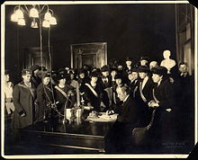 Black and white photograph of many women watching the Kentucky Governor signing a bill
