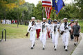 A Navy honor guard leads service members assigned to Kirtland Air Force Base and community supporters in an America Supports You Freedom Walk.