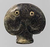 Amulet in the form of a head of an elephant; 3500–3300 BC; serpentine (the green part) and bone (the eyes); 3.5 × 3.6 × 2.1 cm; Metropolitan Museum of Art (New York City)