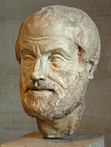 A stone sculpture of the head of a bearded man