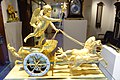 An ormolu chariot clock depicting the god Eros holding a flaming torch, France, first quarter of the 19th century.