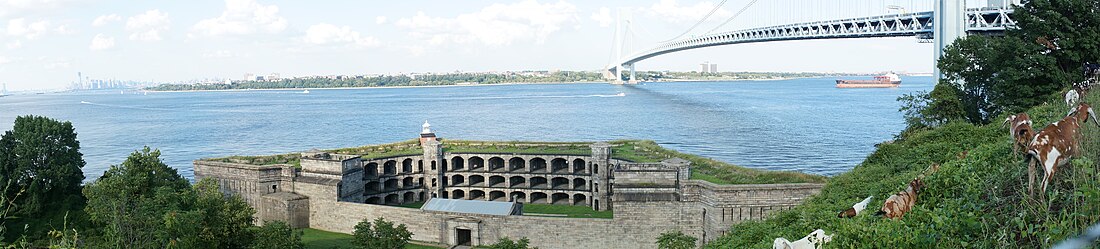 Panorama of the Upper New York Bay viewed from Fort Wadsworth in Staten Island. The Verrazano-Narrows Bridge is visible in the center of the image and Battery Weed is visible in the foreground.