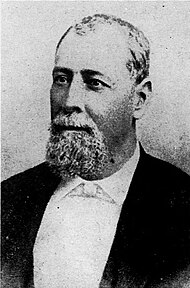 A black-and-white upper body photograph of Justo Rufino Barrios wearing late 19th century formal attire and facing to the left