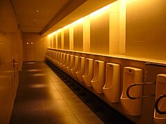 Urinals in Tokyo, Japan; one at far right is fitted with handle bars for people with disabilities
