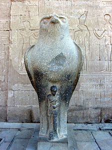 One of two statues of the falcon god Horus behind a smaller depiction of Caesarion at the Temple of Edfu in Edfu, Upper Egypt[25]