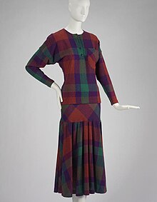 A purple-red-and-green tartan skirt and jumper (sweater) on a mannequin