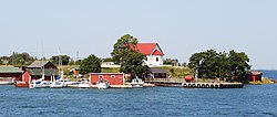 A view of Aspö from the sea. The white building on the top of the hill is the chapel