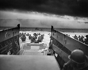 Allied troops storming the Normandy beaches from several landing craft