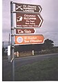 Signpost on the Lacken Road showing variant Irish spelling