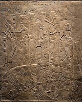 Ashurbanipal's campaign against Elam is triumphantly recorded in this relief showing the destruction of Hamanu. Here, flames rise from the city as Assyrian soldiers topple it with pickaxes and crowbars and carry off the spoils. British Museum.