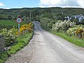 A road crossing the Republic of Ireland-United Kingdom border from the British side. This border is entirely open: the only indication that one is crossing into the Republic of Ireland is a speed limit sign in kilometers per hour (signs in the United Kingdom are in miles per hour).