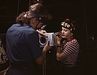 Two women assembling a section of a wing for a WWII fighter plane.
