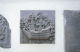 A stone tablet showing a VOC vessel in a wall of the Jakarta History Museum