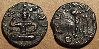 Coin of Kujula Kadphises. Obv Kujula seated cross legged facing, Kharoshti legend: Kuyula Kadaphasa Kushanasa. Rev Zeus on the reverse,[10] Greek legend: ΚΟΖΟΛΑ XOPANOY ZAOOY.