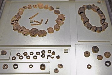 Perforated shells, limestone and variscite pearls. Tumulus A, upper level, 4th millennium.