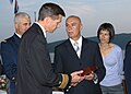 The Montenegro Minister of Defense and a U.S. Navy officer exchange gifts in 2007 during a reception to mark the first year of Montenegro's independence.